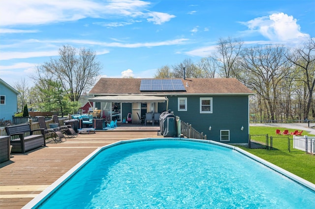 view of pool with a wooden deck, a fenced in pool, a gate, a lawn, and fence