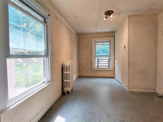 635 N Division St, Peekskill, NY 10566 - unfurnished room featuring radiator heating unit, a drop ceiling, and a textured wall