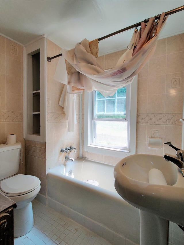 635 N Division St, Peekskill, NY 10566 - bathroom featuring toilet, tile patterned floors, and tile walls