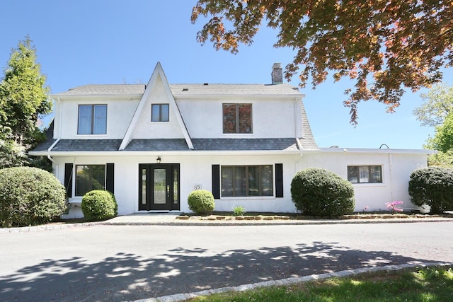 85 S Harrison Ave, Congers, NY 10920 - view of front facade with a chimney, a shingled roof, and stucco siding