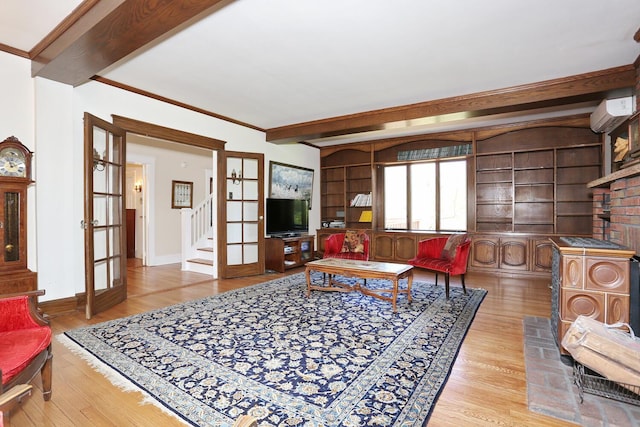 85 S Harrison Ave, Congers, NY 10920 - living area with a wall mounted AC, beam ceiling, wood finished floors, baseboards, and stairs