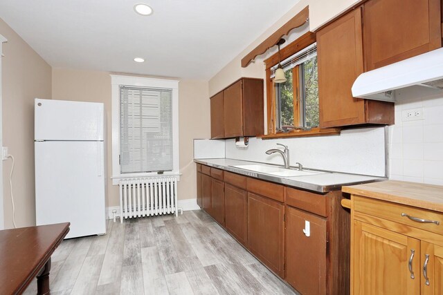 85 S Harrison Ave, Congers, NY 10920 - kitchen with freestanding refrigerator, radiator, light countertops, a sink, and light wood finished floors