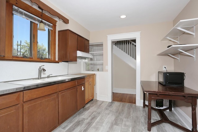 85 S Harrison Ave, Congers, NY 10920 - kitchen with light wood-style floors, a sink, baseboards, and under cabinet range hood