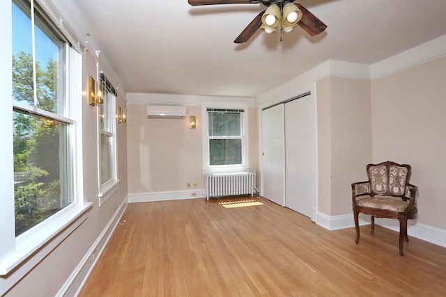 85 S Harrison Ave, Congers, NY 10920 - interior space featuring an AC wall unit, baseboards, radiator, and light wood-type flooring