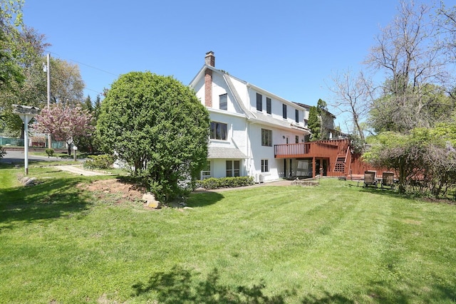 85 S Harrison Ave, Congers, NY 10920 - back of house with a lawn, stucco siding, a chimney, and a deck