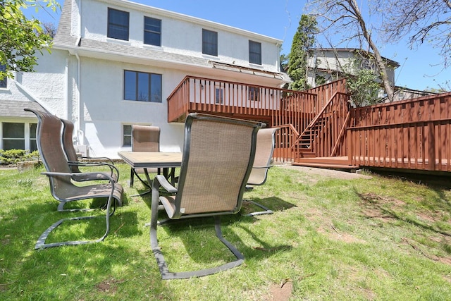 85 S Harrison Ave, Congers, NY 10920 - back of property with stairs, a shingled roof, stucco siding, a deck, and a lawn
