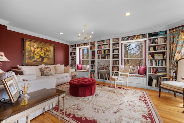 sitting room with crown molding, an inviting chandelier, built in features, recessed lighting, and wood finished floors