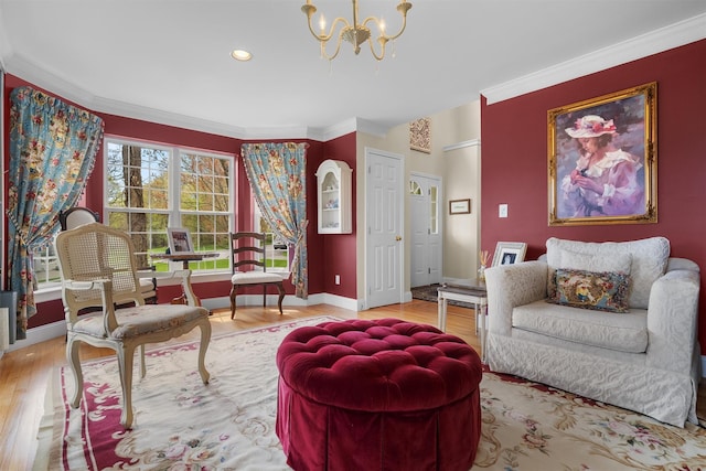 sitting room with crown molding, baseboards, an inviting chandelier, and wood finished floors