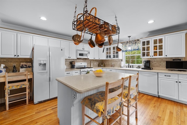 kitchen with recessed lighting, white appliances, and tasteful backsplash