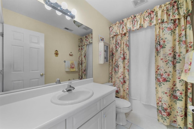 bathroom with vanity, tile patterned flooring, toilet, and visible vents