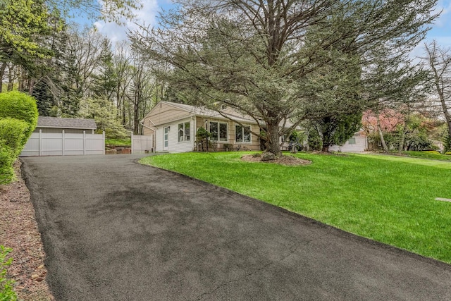 view of front of property with a front lawn and a garage