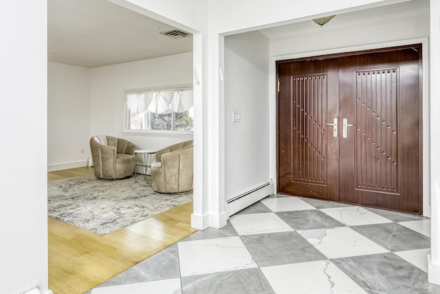 entryway featuring a baseboard heating unit, marble finish floor, visible vents, baseboards, and a baseboard radiator