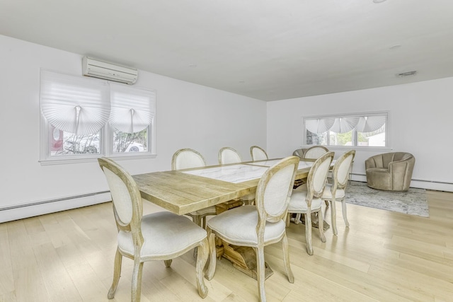 dining space featuring light wood finished floors, a wall mounted AC, and a baseboard radiator