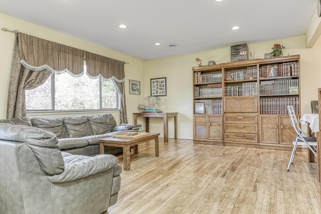 sitting room featuring baseboards, recessed lighting, and wood finished floors