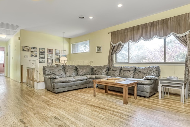 living area featuring visible vents, plenty of natural light, and light wood finished floors