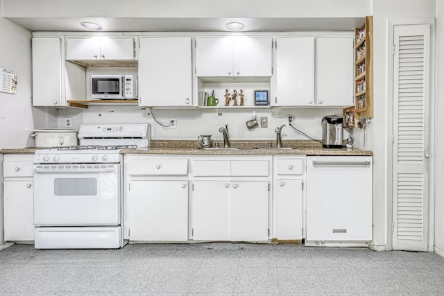 kitchen featuring light stone countertops, white appliances, open shelves, and white cabinets