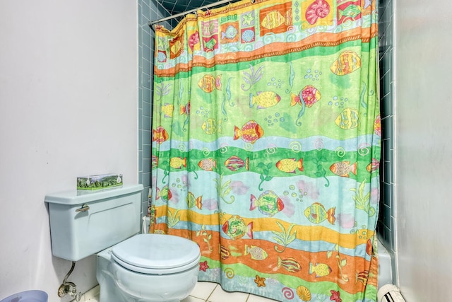 bathroom with tile patterned floors, a baseboard heating unit, and toilet