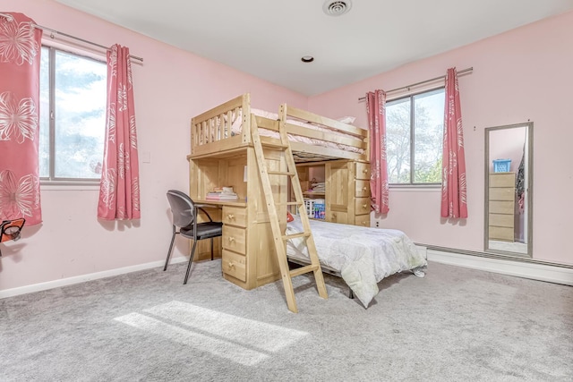 bedroom with visible vents, baseboard heating, carpet, and baseboards