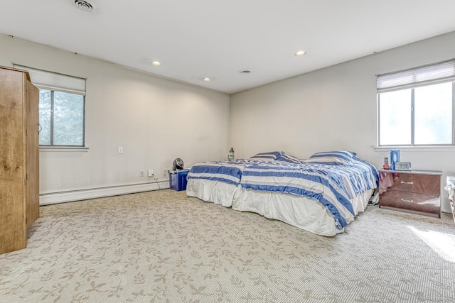 carpeted bedroom featuring recessed lighting and a baseboard heating unit