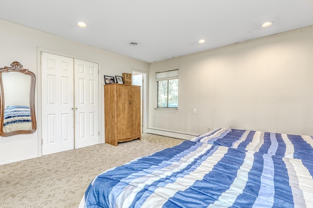 carpeted bedroom with recessed lighting, baseboards, a baseboard heating unit, and a closet