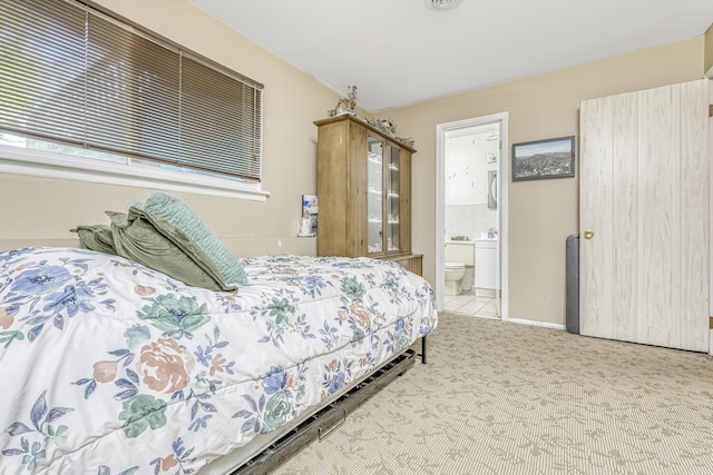 carpeted bedroom with ensuite bath