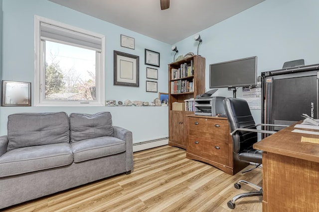 office area with light wood-type flooring, a ceiling fan, and a baseboard radiator