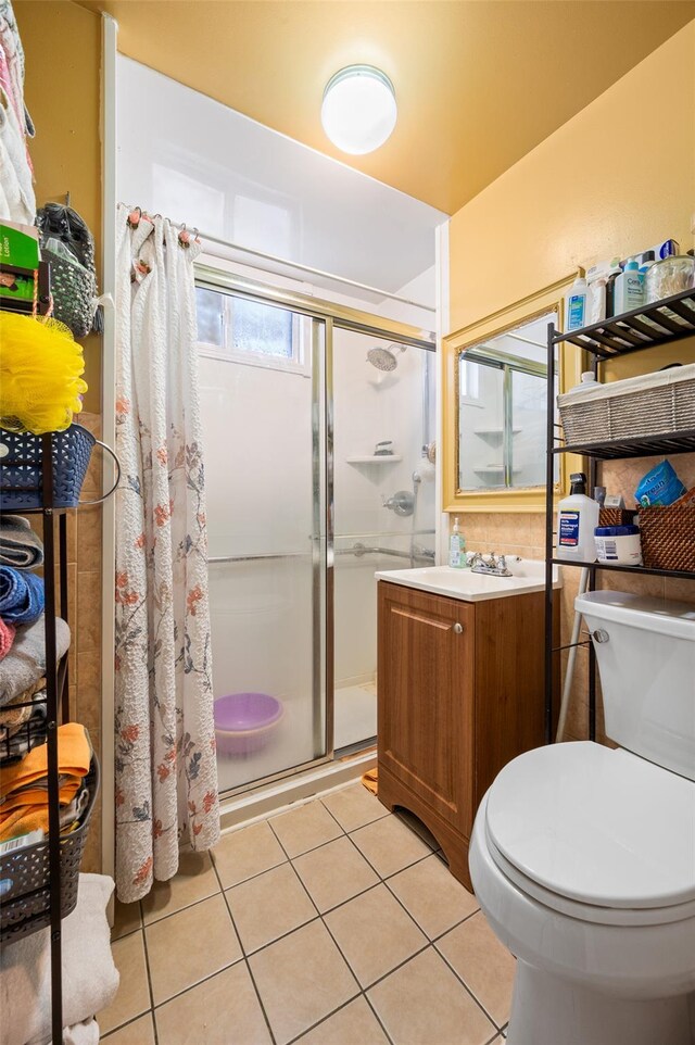 26-18 92nd St, East Elmhurst, NY 11369 - bathroom with a stall shower, toilet, tile patterned floors, and vanity