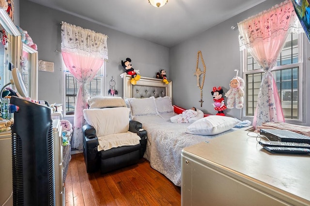 26-18 92nd St, East Elmhurst, NY 11369 - bedroom with wood-type flooring and multiple windows