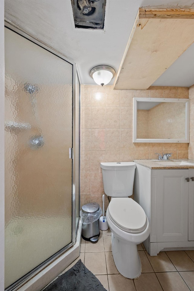 26-18 92nd St, East Elmhurst, NY 11369 - full bathroom featuring a shower stall, tile patterned flooring, toilet, vanity, and tile walls