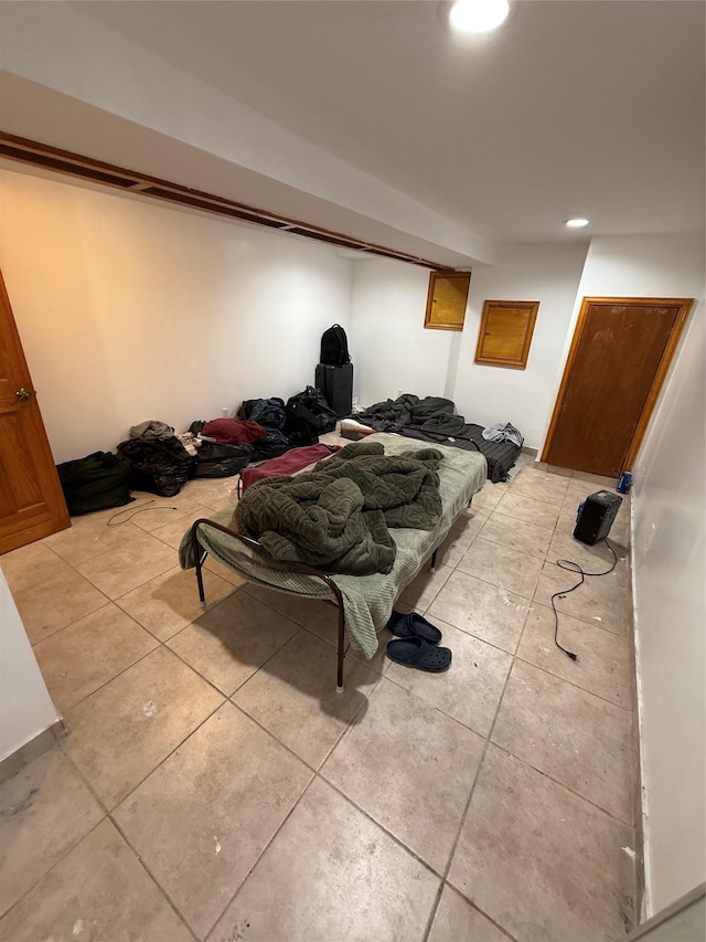 bedroom featuring light tile patterned floors and recessed lighting