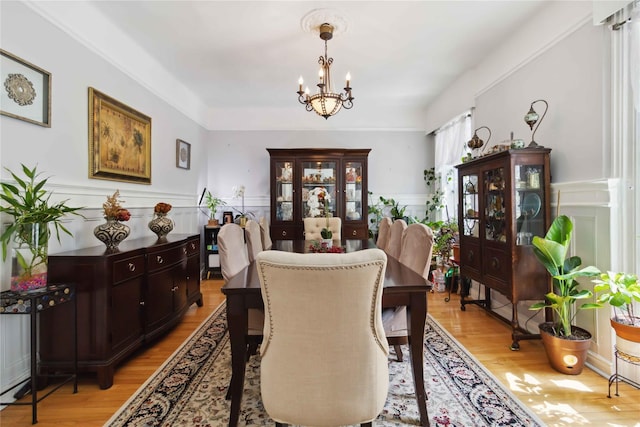 243 W 98th St Unit 2C, New York Manhattan, NY 10025 - dining area featuring an inviting chandelier, wainscoting, and light wood-style flooring