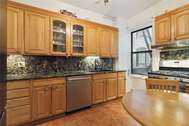 243 W 98th St Unit 2C, New York Manhattan, NY 10025 - kitchen featuring appliances with stainless steel finishes, light tile patterned floors, a sink, glass insert cabinets, and under cabinet range hood