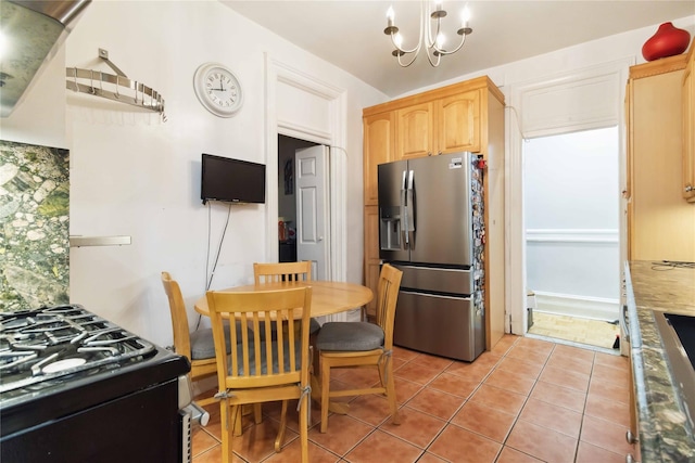 243 W 98th St Unit 2C, New York Manhattan, NY 10025 - kitchen featuring light brown cabinetry, a notable chandelier, stainless steel fridge, range with gas stovetop, and light tile patterned floors
