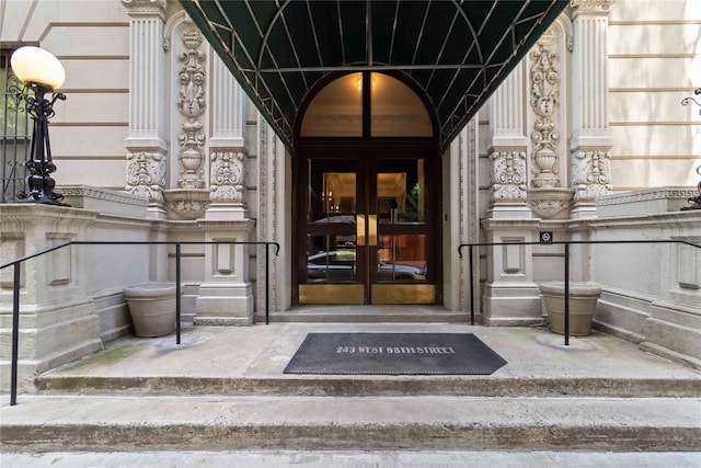 243 W 98th St Unit 2C, New York Manhattan, NY 10025 - view of exterior entry featuring french doors and stone siding