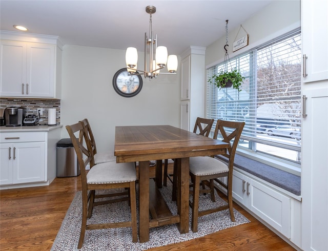 dining space featuring dark wood-style floors, recessed lighting, and a chandelier