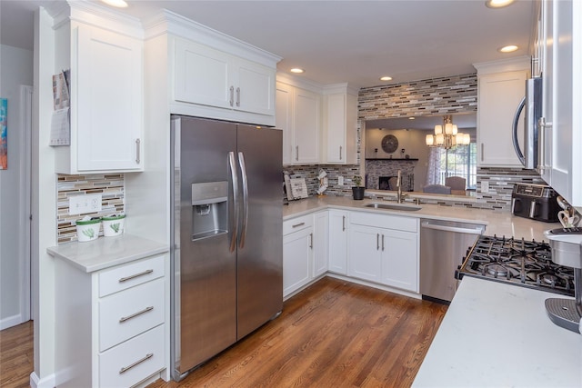 kitchen with appliances with stainless steel finishes, decorative backsplash, recessed lighting, and a sink