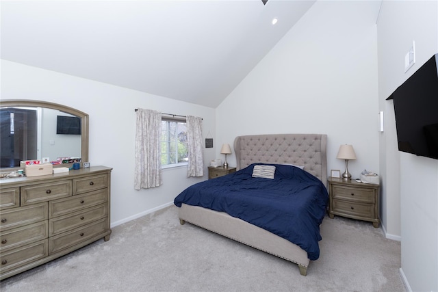 bedroom featuring baseboards, high vaulted ceiling, and light colored carpet