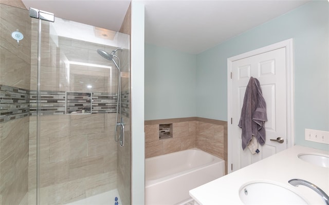 full bath with a shower stall, double vanity, a bath, and a sink