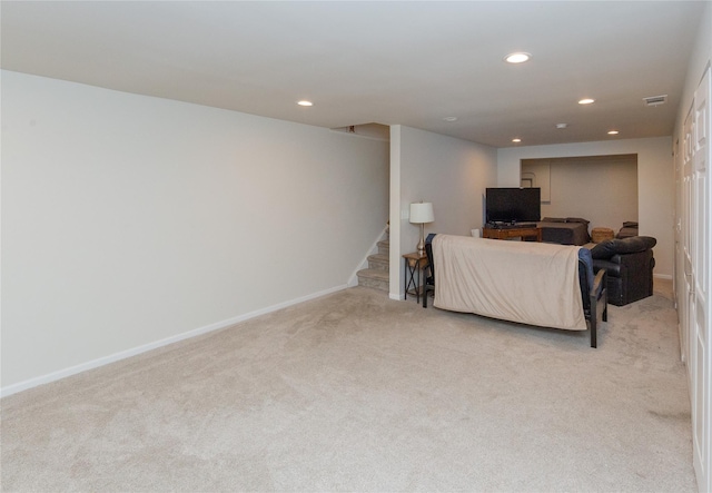 living room featuring visible vents, baseboards, recessed lighting, light carpet, and stairs
