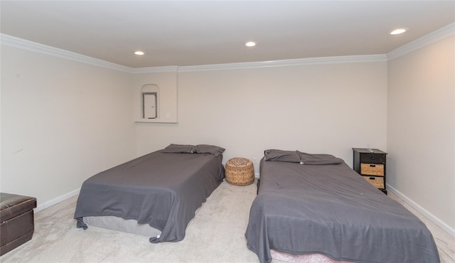 bedroom with baseboards, crown molding, and carpet