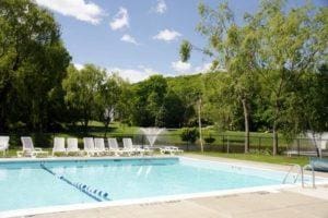 community pool featuring a patio and fence