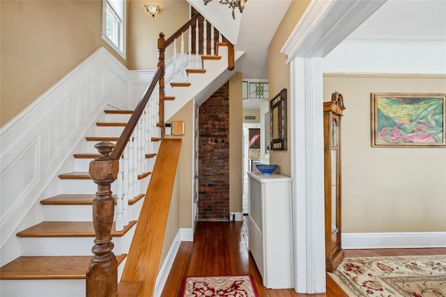 stairway featuring baseboards and wood finished floors