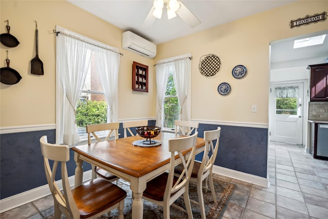 dining area featuring plenty of natural light, wainscoting, ceiling fan, and a wall unit AC