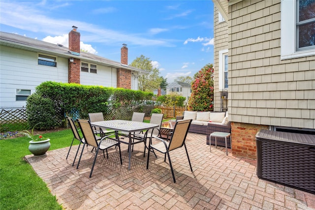 view of patio / terrace featuring fence, outdoor dining area, and an outdoor living space