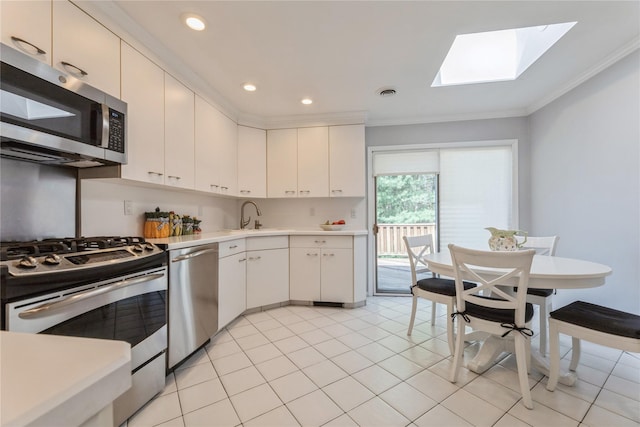 28 Verona Ct, New City, NY 10956 - kitchen with ornamental molding, light countertops, a sink, appliances with stainless steel finishes, and a skylight
