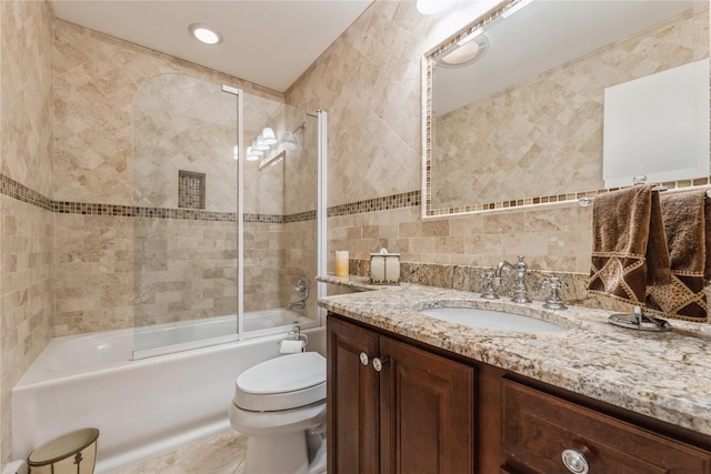 28 Verona Ct, New City, NY 10956 - bathroom with decorative backsplash, tile walls, vanity, toilet, and shower / bath combination with glass door