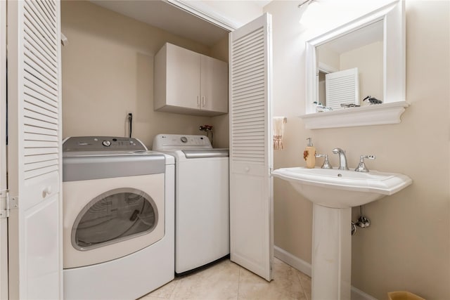 28 Verona Ct, New City, NY 10956 - clothes washing area with cabinet space, separate washer and dryer, baseboards, and light tile patterned floors