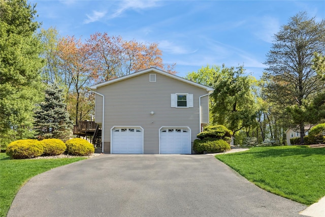 28 Verona Ct, New City, NY 10956 - view of side of home featuring an attached garage, a lawn, and driveway