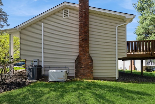 28 Verona Ct, New City, NY 10956 - view of property exterior featuring a lawn, a chimney, central AC unit, and a wooden deck