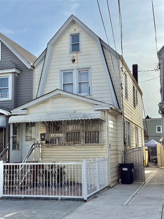101-14 118th St, Richmond Hill S, NY 11419 - dutch colonial with a gambrel roof, a fenced front yard, and a gate